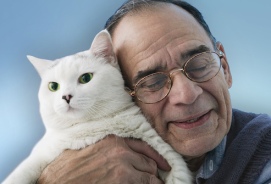 Older Man Hugging a Cat